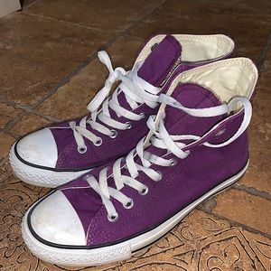 Purple Converse high tops.